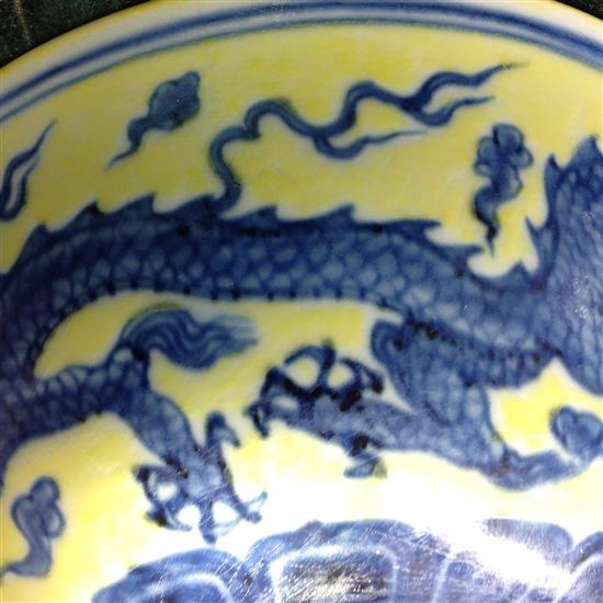 A Chinese yellow ground dragon and phoenix bowl, Xuande six character mark and possibly of the period, 19.5cm, museum restoration, sc